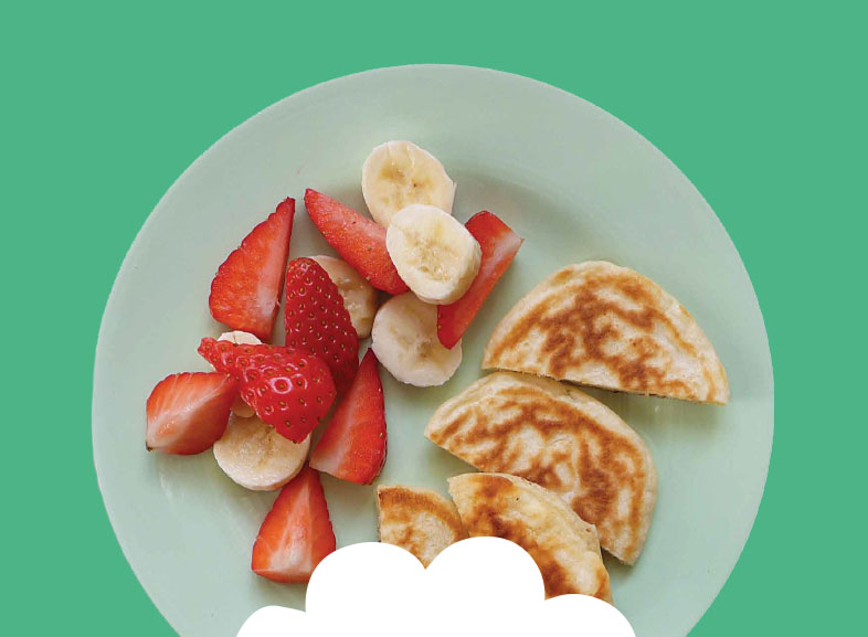 Scotch pancakes with sliced banana and strawberries Image